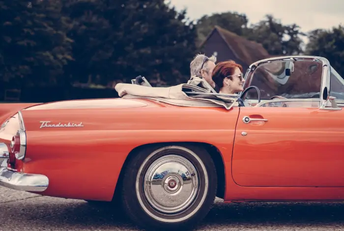 Couple Riding Red Ford Thunderbird during Daytime · Free ...